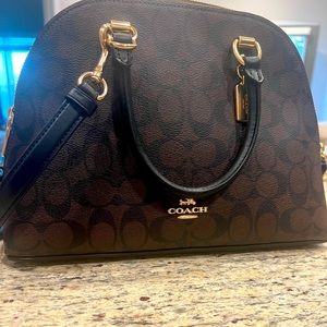 12” across at base, 8.5” high. Crossbody shoulder strap. Brand new